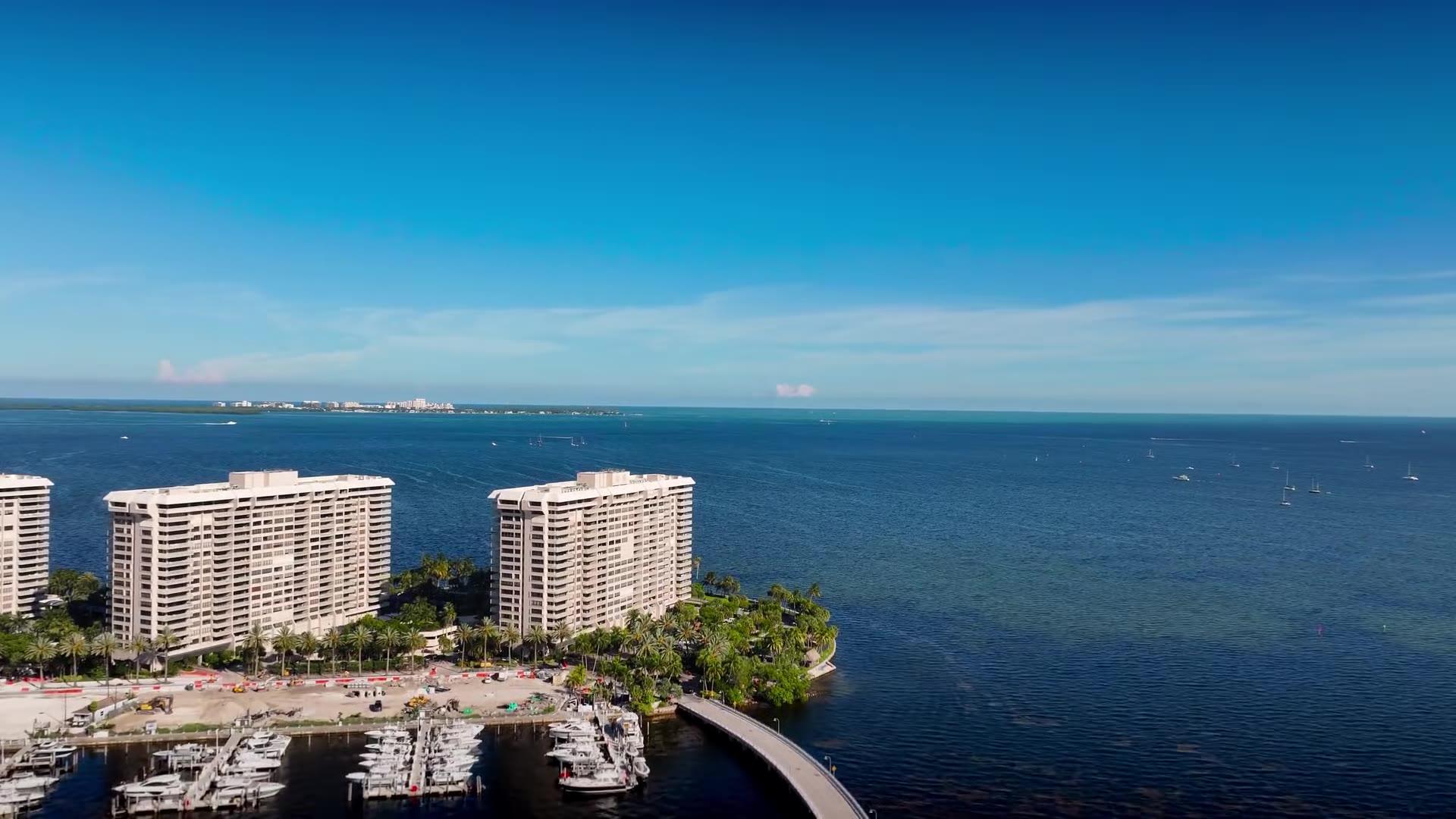 Aerial footage of the South Florida coastline, waterfront towers, marinas and Boca Raton at sunset